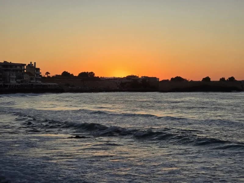 Orange sunset glowing above the water